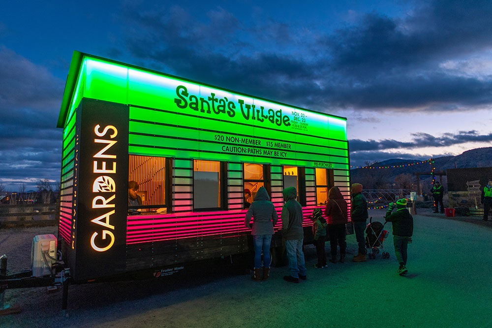 Trailer Made Santa’s Village ticket booth at Chatfield Farms, illuminated in green and pink as guests approach the service windows